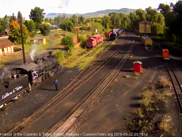 9.2.16 One of the road crew, who has come up to begin his work, stands back as a hostlers washes off the 484.jpg