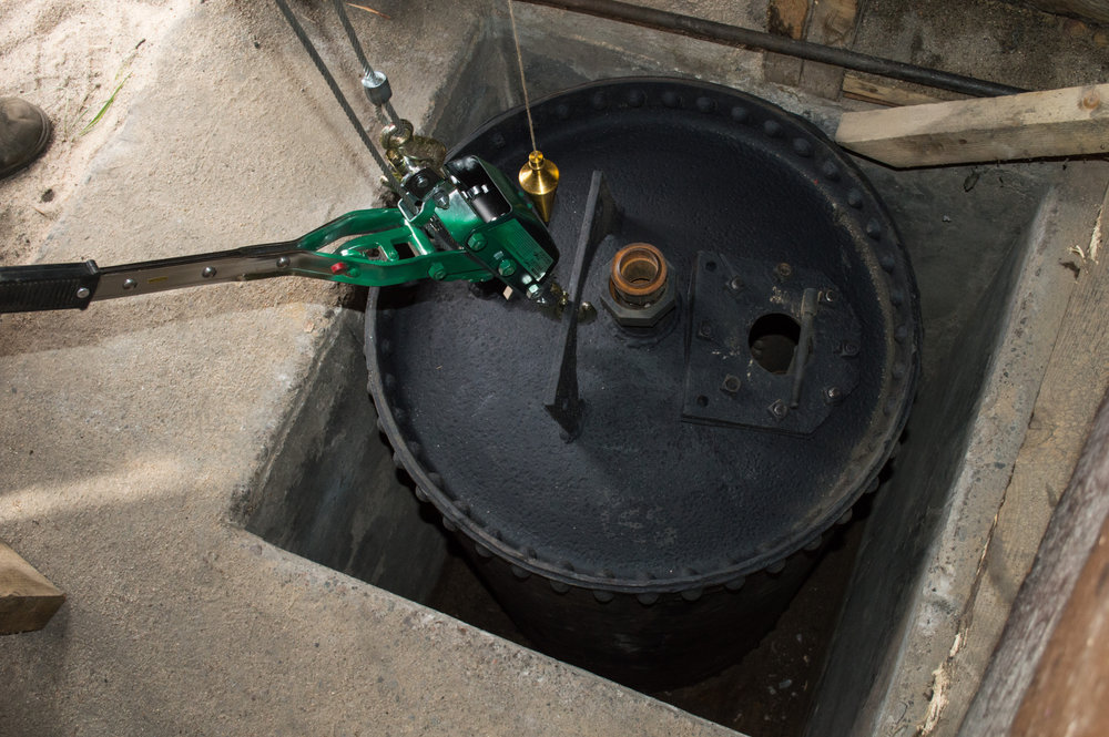 7-26-17 Before the tank is lowered the last few inches a plumb bob was lowered from the roof through the pipe hole so the tank could be centered.jpg