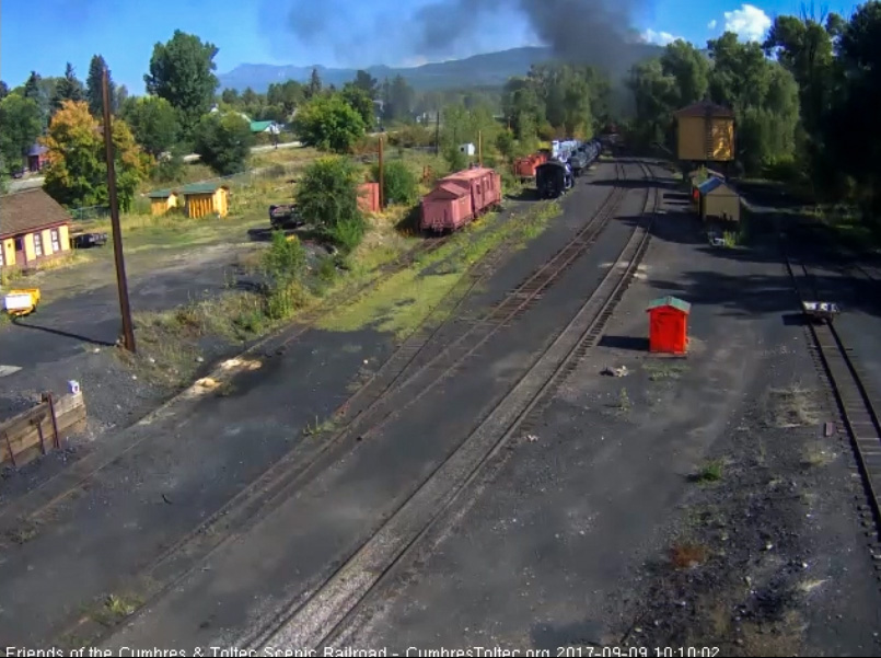 9-9-17 The last cars of the train round the curve north of the yard as the smoke hangs thick.jpg