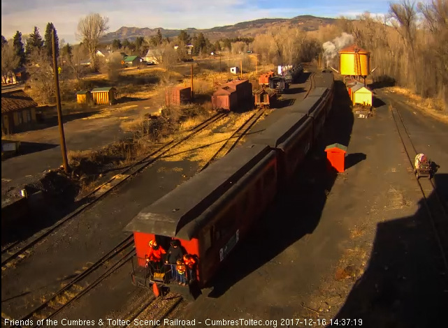 12-16-17 As the 4th train gets underway again, we see a family and the conductor on the rear platform.jpg