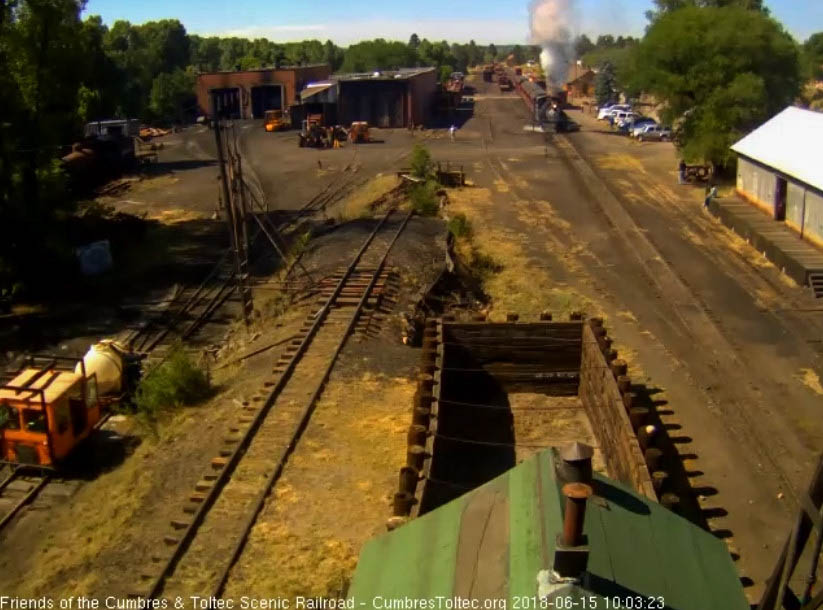 2018-06-15 The 487 gets its 7 car train 216 underway as the second fire patrol speeder fills its water tank.jpg