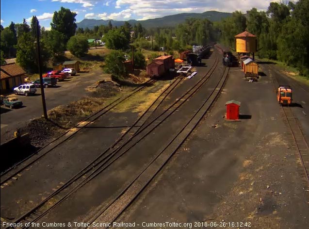 2018-06-26 The 488 passes the tank as the last cars of the train enter the yard.jpg