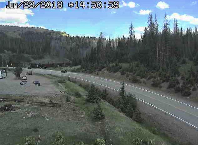 2018-06-28 Train 215 steams into Cumbres as it crosses route 17.jpg