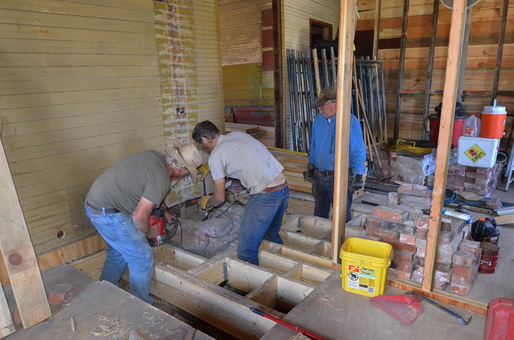 2018-06-28 With the flooring up, work begins to rebuild the fireplace in the car inspector's house.jpg