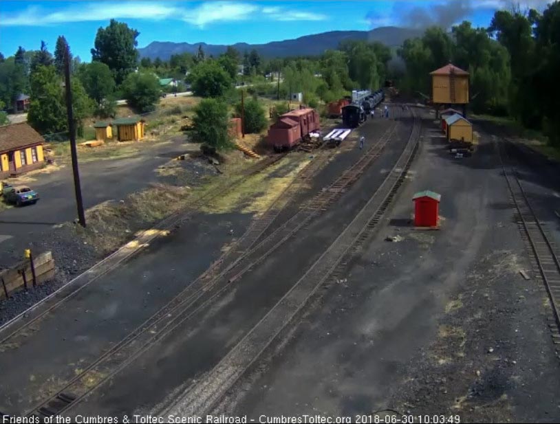 2018-06-30 The last cars of the train are rounding the curve as we see quite a few people coming back from watching the train leave.jpg