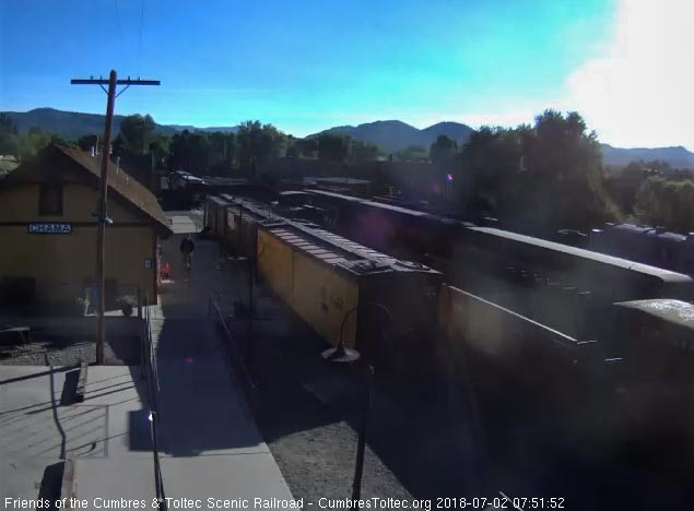 2018-07-02 Through the sun's glare we can see the consist of the special train sitting on the depot track and the regular train behind it.jpg