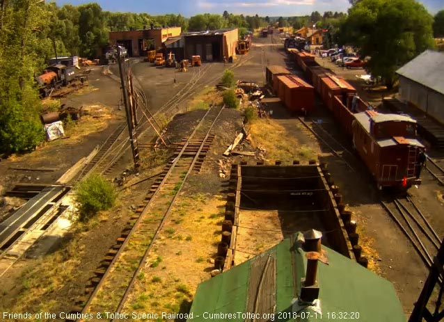 2018-07-11 The caboose passes the woodshop as the conductor looks at the train.jpg