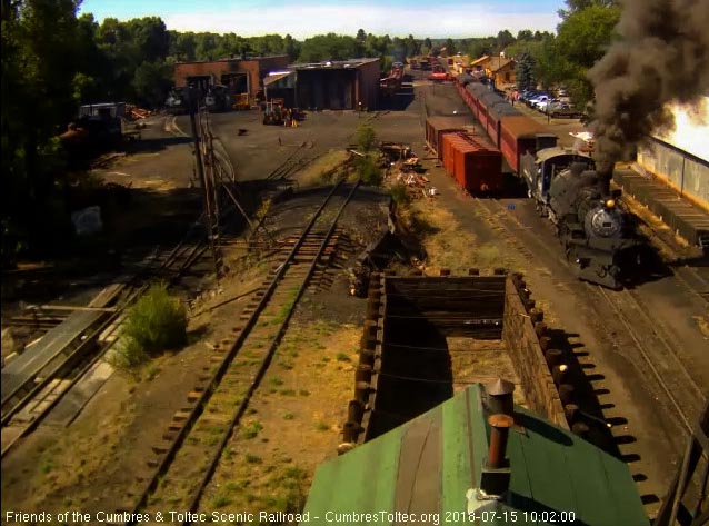 2018-07-15 The 489 comes by the woodshop as the fire truck crosses behind the train.jpg