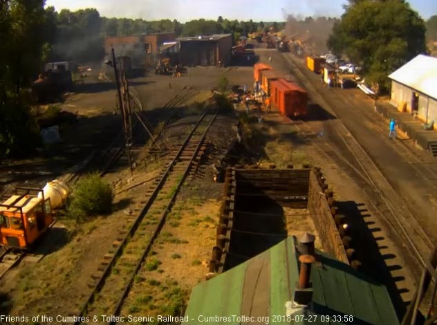 2018-07-27 The 484 has coupled onto the train as one of the speeders fills its water trailer.jpg