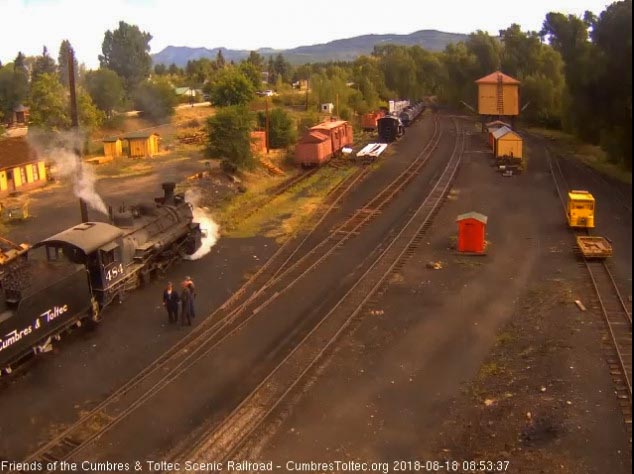 2018-08-18 The loader dumps in another bucket full of coal as the other hostler talks to some fans.jpg