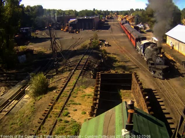 2018-08-26 As the 489 comes past the woodshop, we see the gray cab roof from the blown ash.jpg