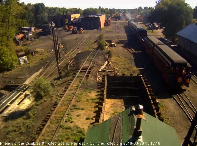 8-08-29 The trainman is standing on the steps of the New Mexico as it passes the woodshop.jpg