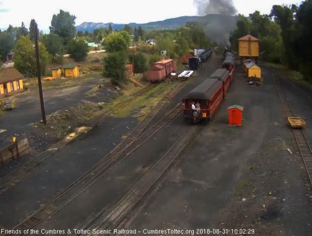 2018-08-31 Two fans are enjoying the platform of the parlor as the train leaves Chama.jpg