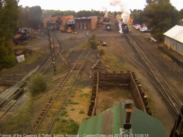 2018-09-04 The 487 gets its 7 car train underway as the freight waits in the background.jpg