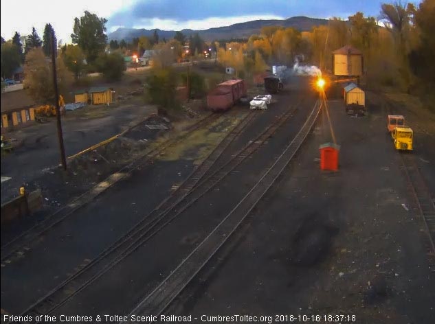 2018-10-16 The golden glow of the headlight shines out as the 484 passes the tank.jpg