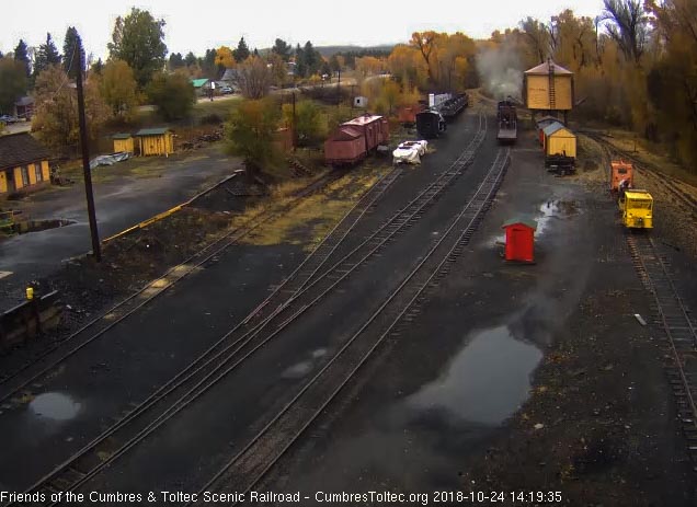 2018-10-24 The 484 passes the tank with a flat car and caboose.jpg