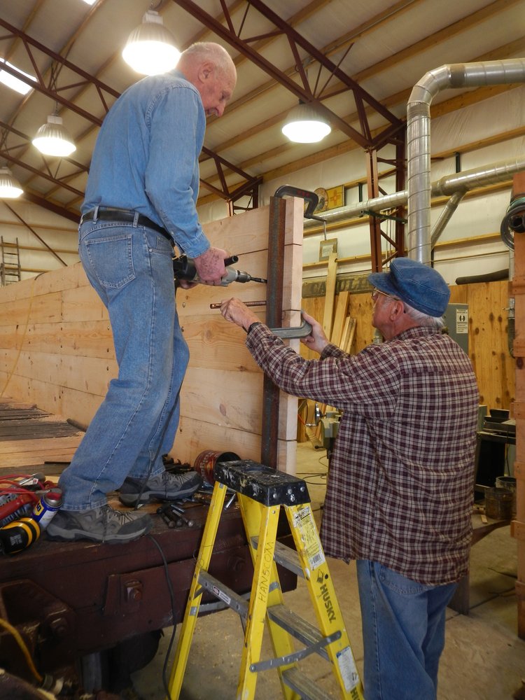 Sam and jim installing angle steel to support ends on the Rider gon.  End will be installed by Marvin and the shop crew..jpg