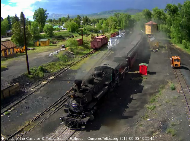 6.5.16 Under a backdrop of dark clouds 484 brings train 215 into Chama.jpg